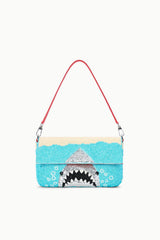 Turquoise sequin shoulder bag with red handles and shark graphic front.