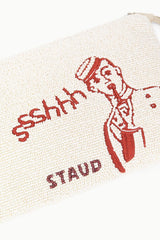 Beaded pouch corner close-up with red “sshh” lettering and figure illustration