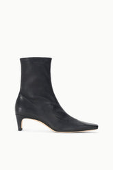Black ankle sock boot with tapered toe and low block heel.