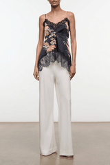 Black silk camisole top with floral embroidery, lace trim, and thin spaghetti straps