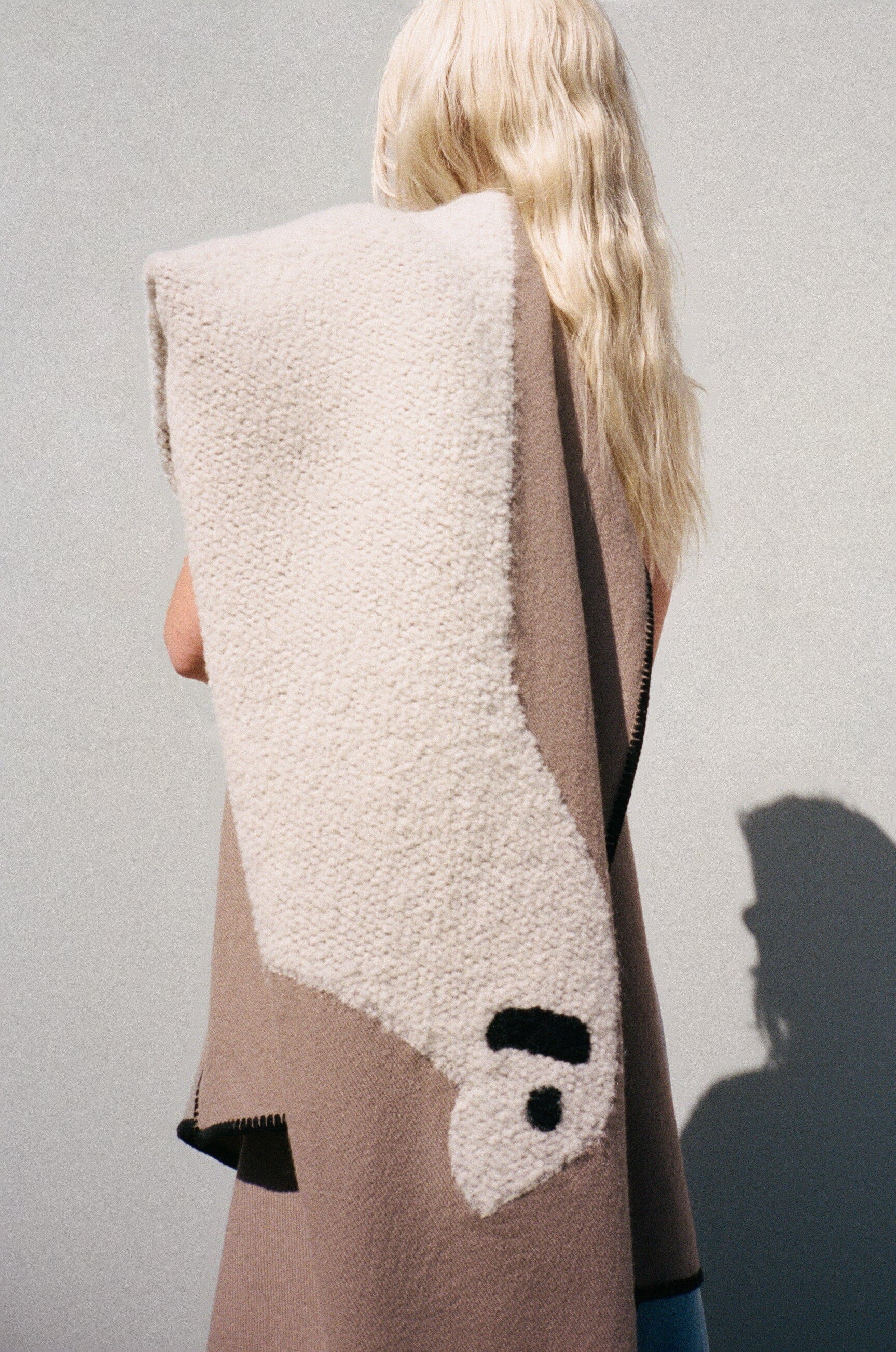 Sheep throw blanket draped, showing cream sherpa panel with black face details