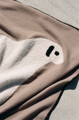 Close-up of sheep face motif on cream sherpa side of truffle throw blanket