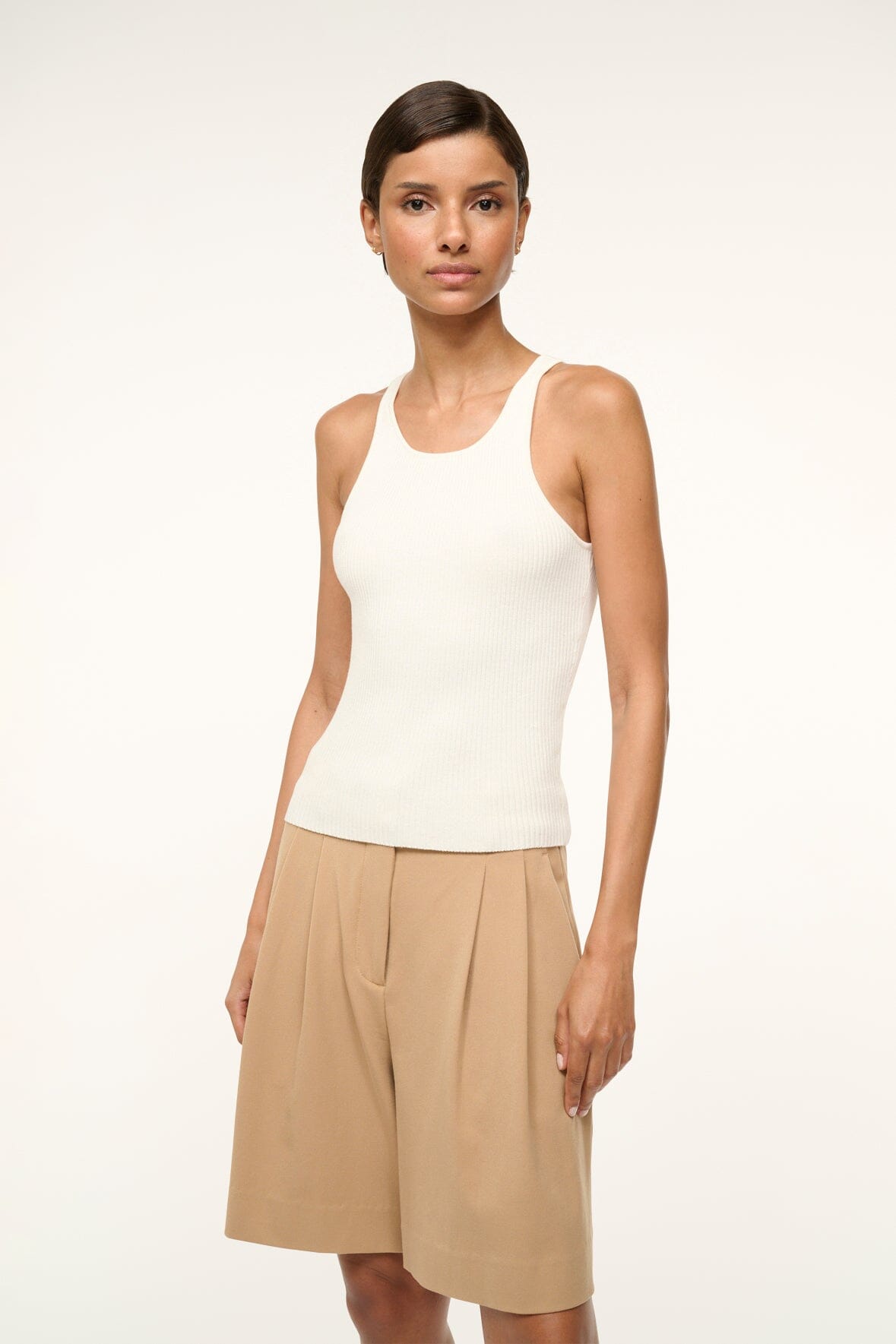 Women’s white sleeveless tank top with scoop neck and fitted silhouette
