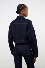 Indigo denim jacket, back view, cropped length with flap pockets and dark buttons