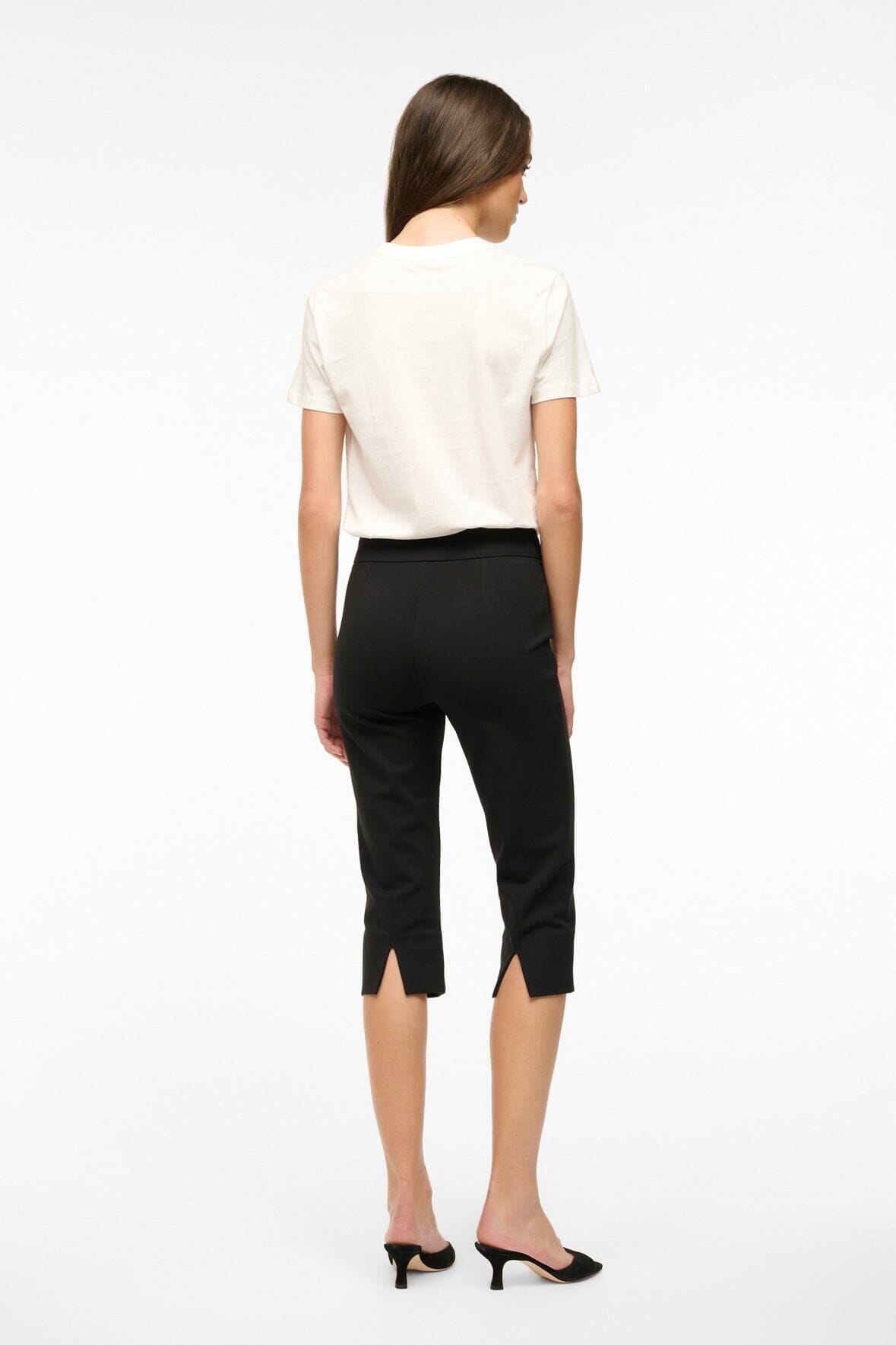 Black cropped pants, back view; slim straight fit