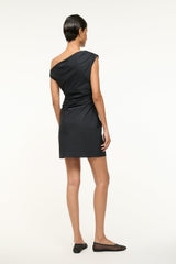 Black mini Phare dress back view with draped one-shoulder and gathered seam