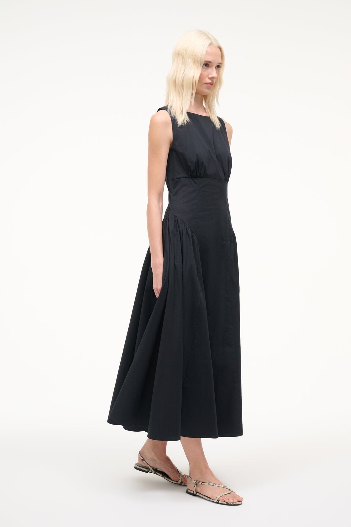 Sleeveless black midi dress with gathered waist and flared skirt