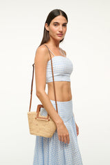 Raffia mini bucket bag in natural tan with brown handle and woven raffia texture