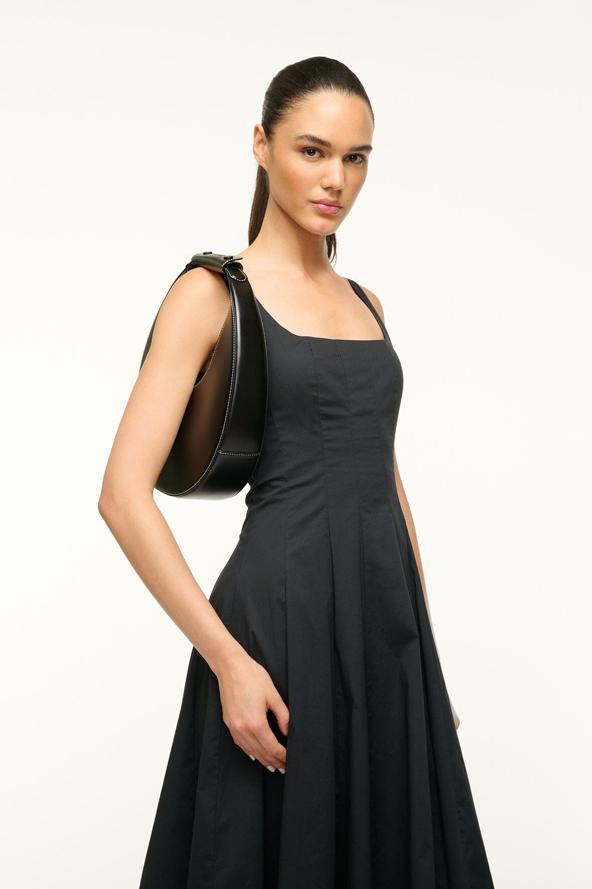 Black crescent hobo bag carried over the shoulder by the top handle