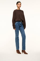 Mahogany suede ankle boot worn with blue jeans; block heel and pointed toe