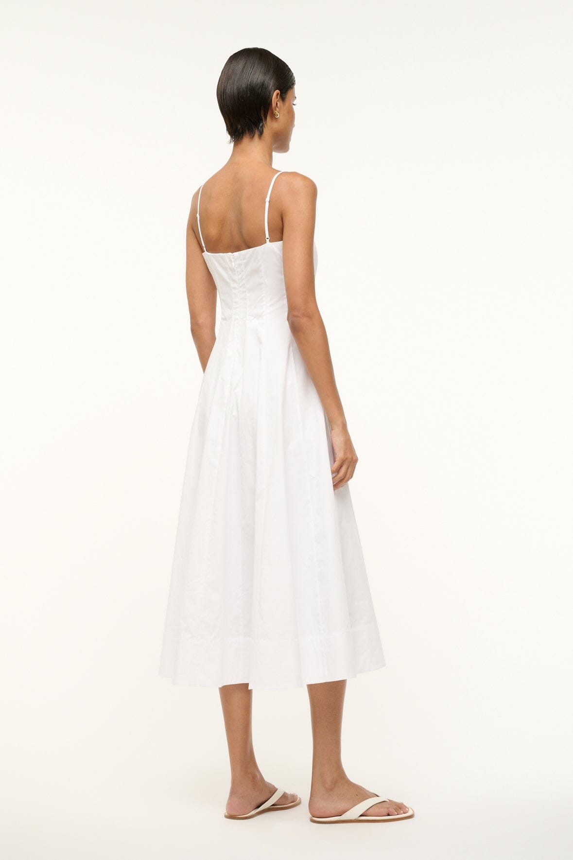 White midi dress back view with thin straps and flared skirt