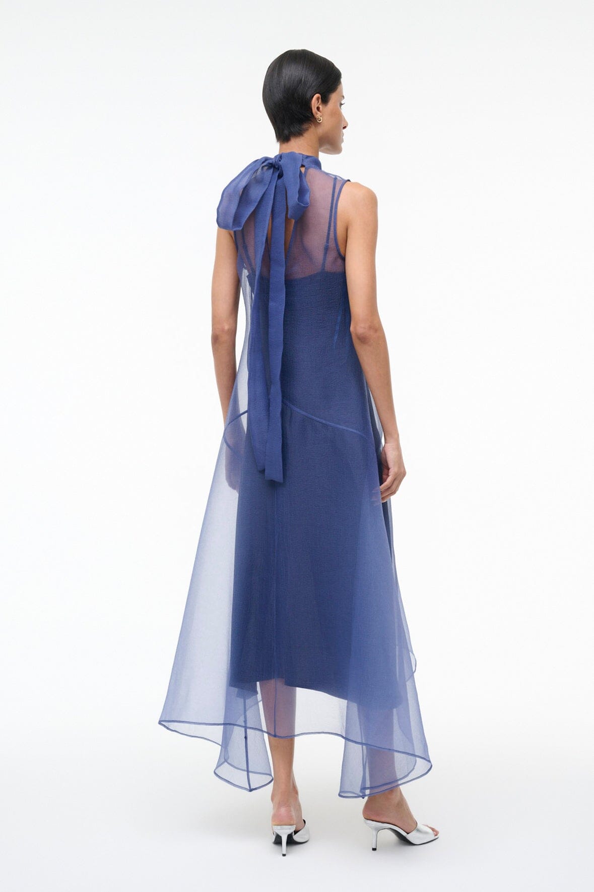 Navy back view sleeveless dress with tie detail at upper back and sheer hem