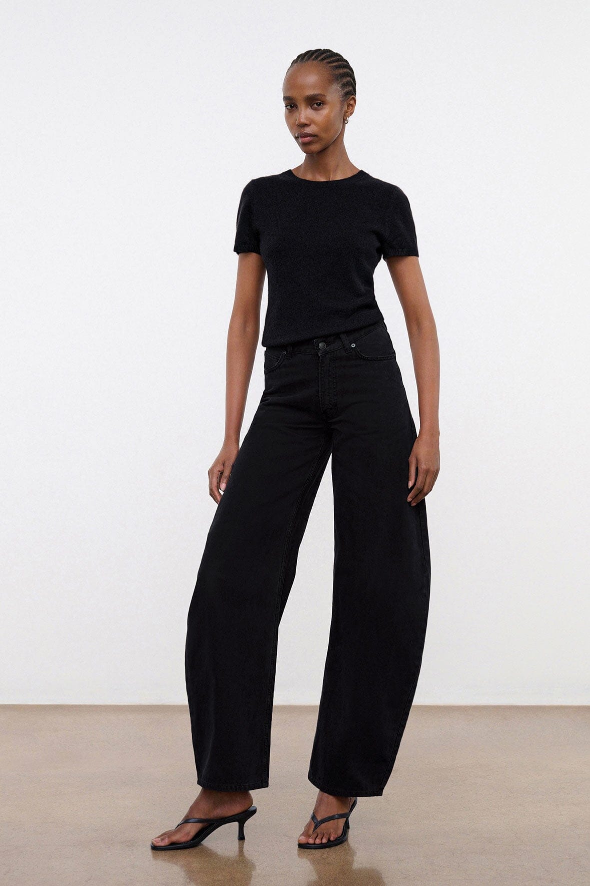 Black denim jeans waistband with button closure and belt loops