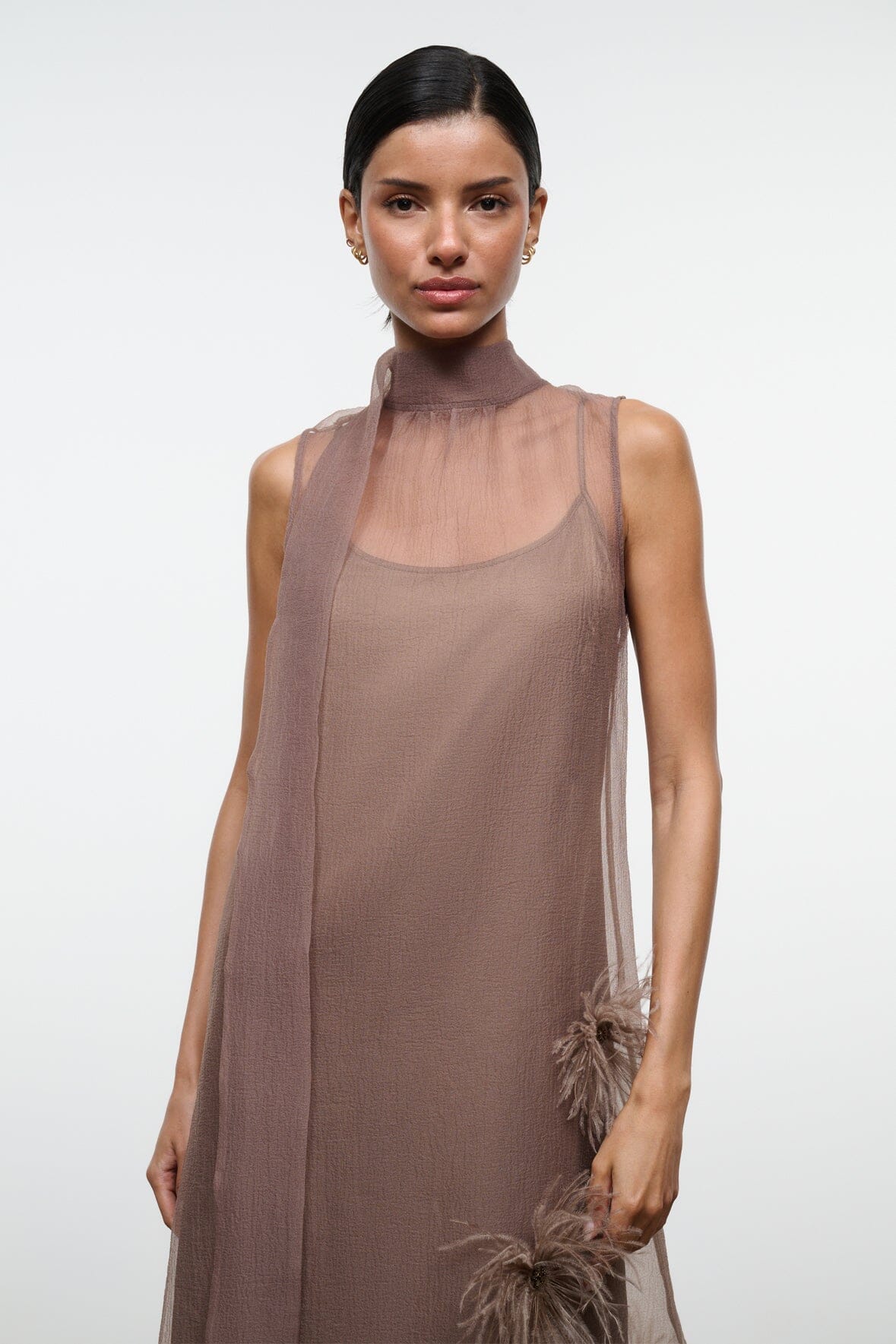 Taupe sleeveless maxi dress with feather applique detail on the skirt
