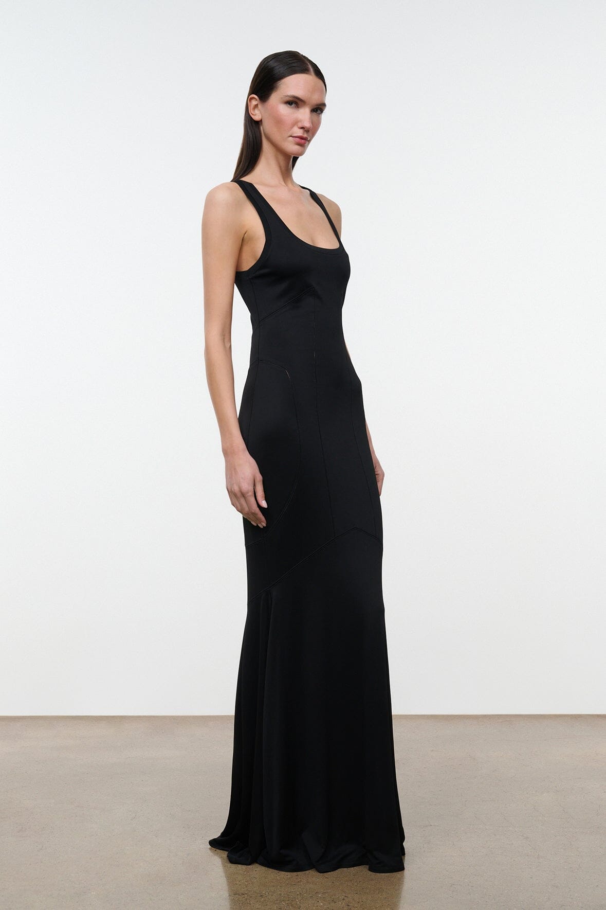 Black sleeveless maxi dress with scoop neckline, thin straps, fitted silhouette