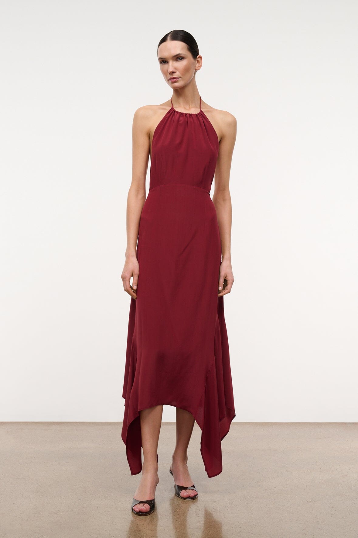Silk halter dress in dark red with draped asymmetrical hem