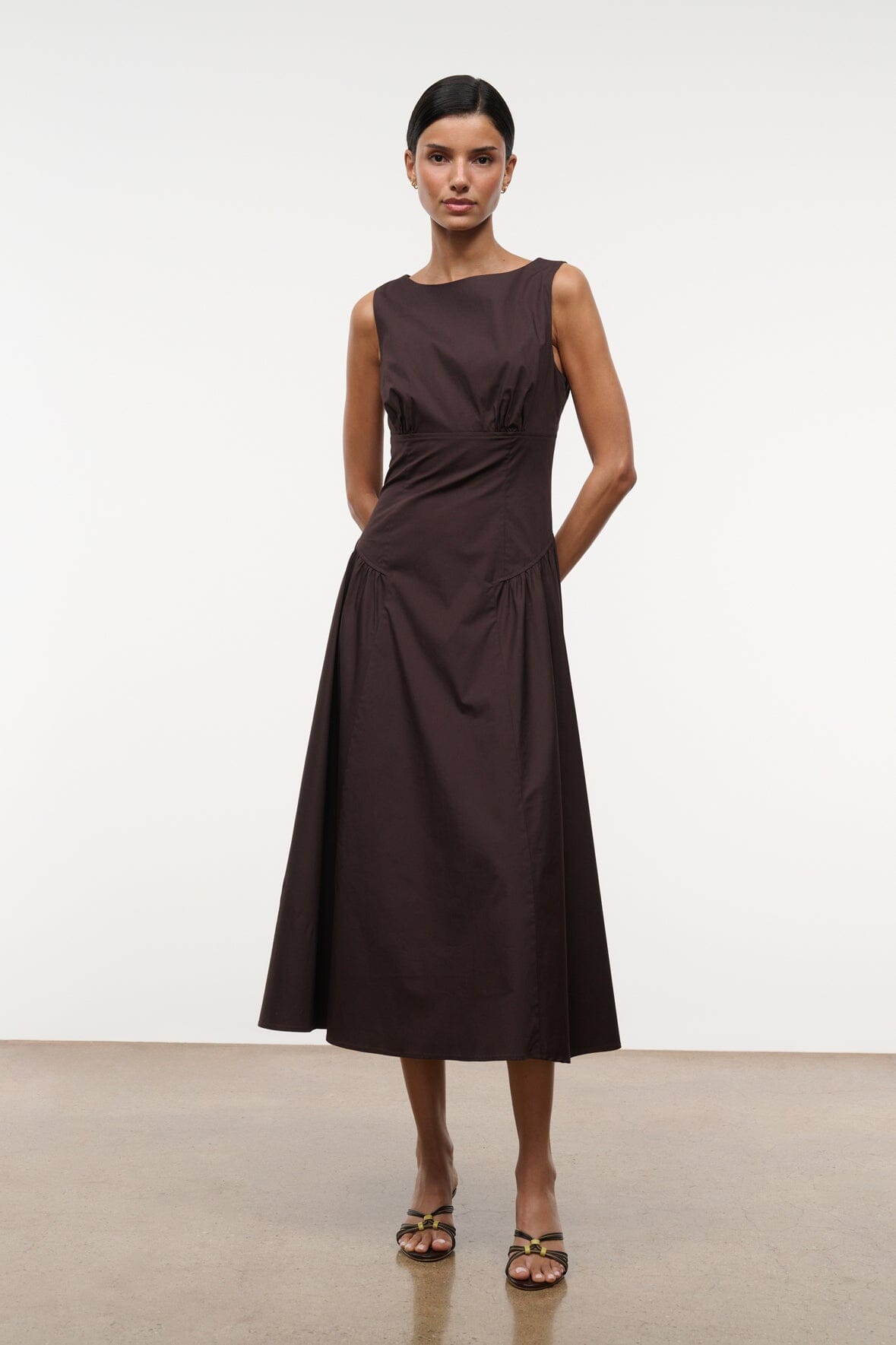 Brown sleeveless midi dress with ruched waist and flared skirt, scoop neckline.