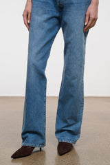 Dark brown ankle boot with pointed toe and kitten heel, worn with jeans