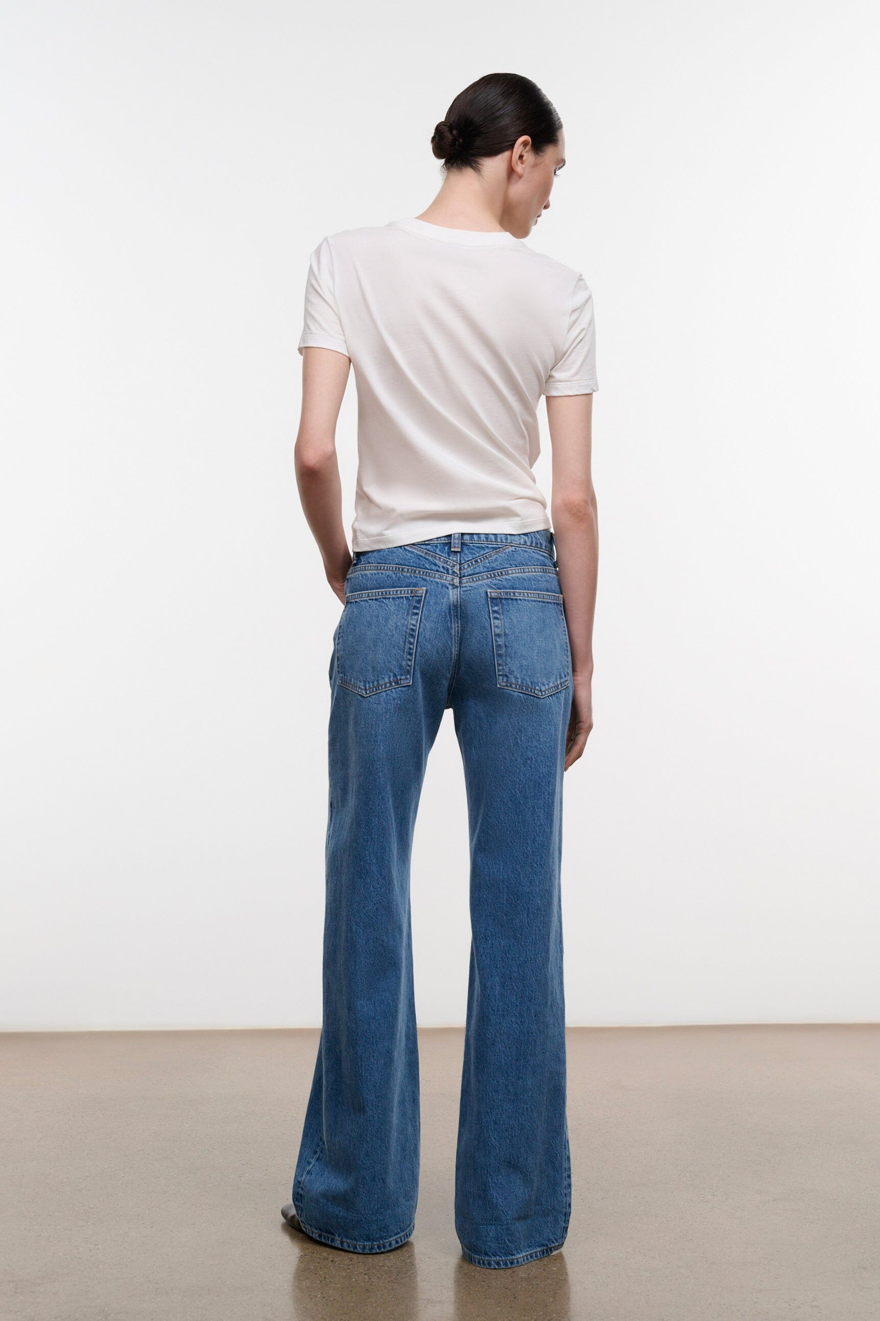 Relaxed-fit vintage wash jeans, rear view with belt loops and pockets