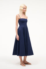 Navy midi dress with spaghetti straps, fitted bodice, and full skirt
