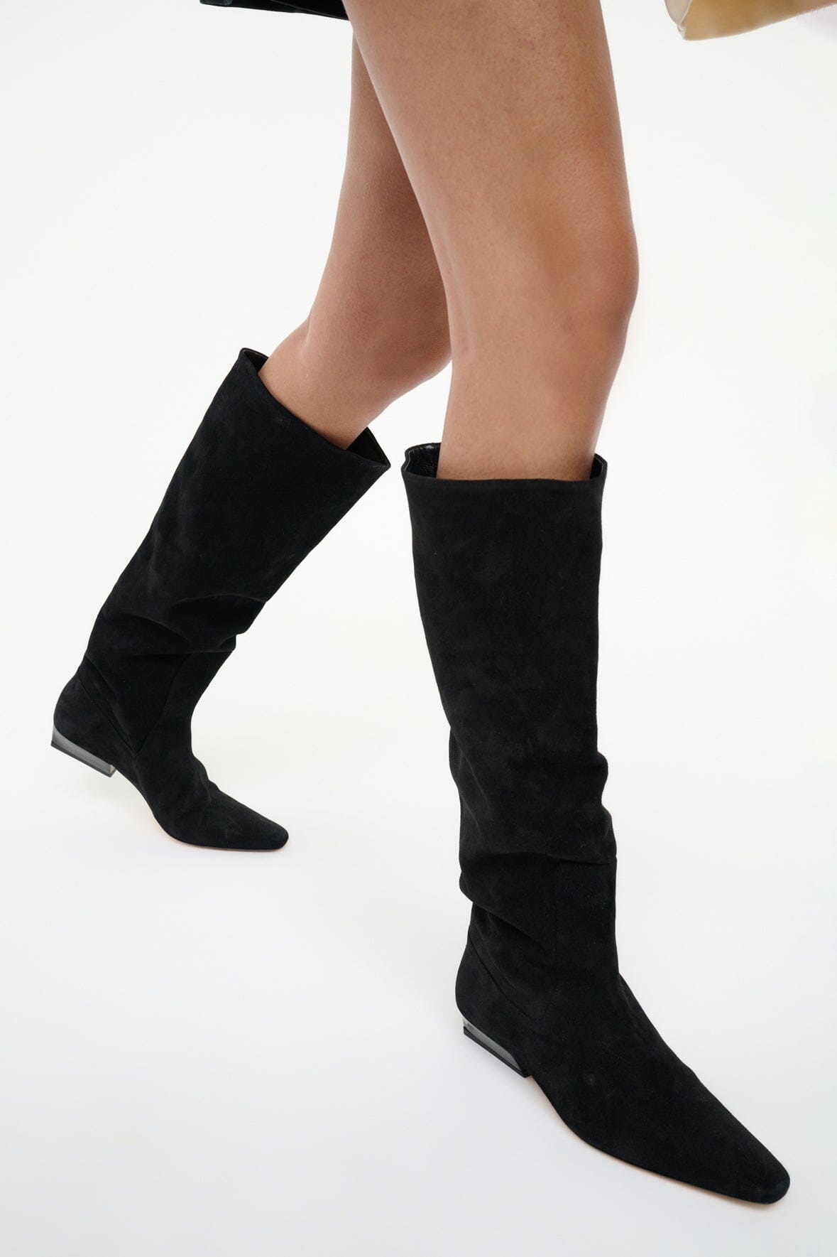 Black suede flat knee boots with pointed toe and pull-on opening