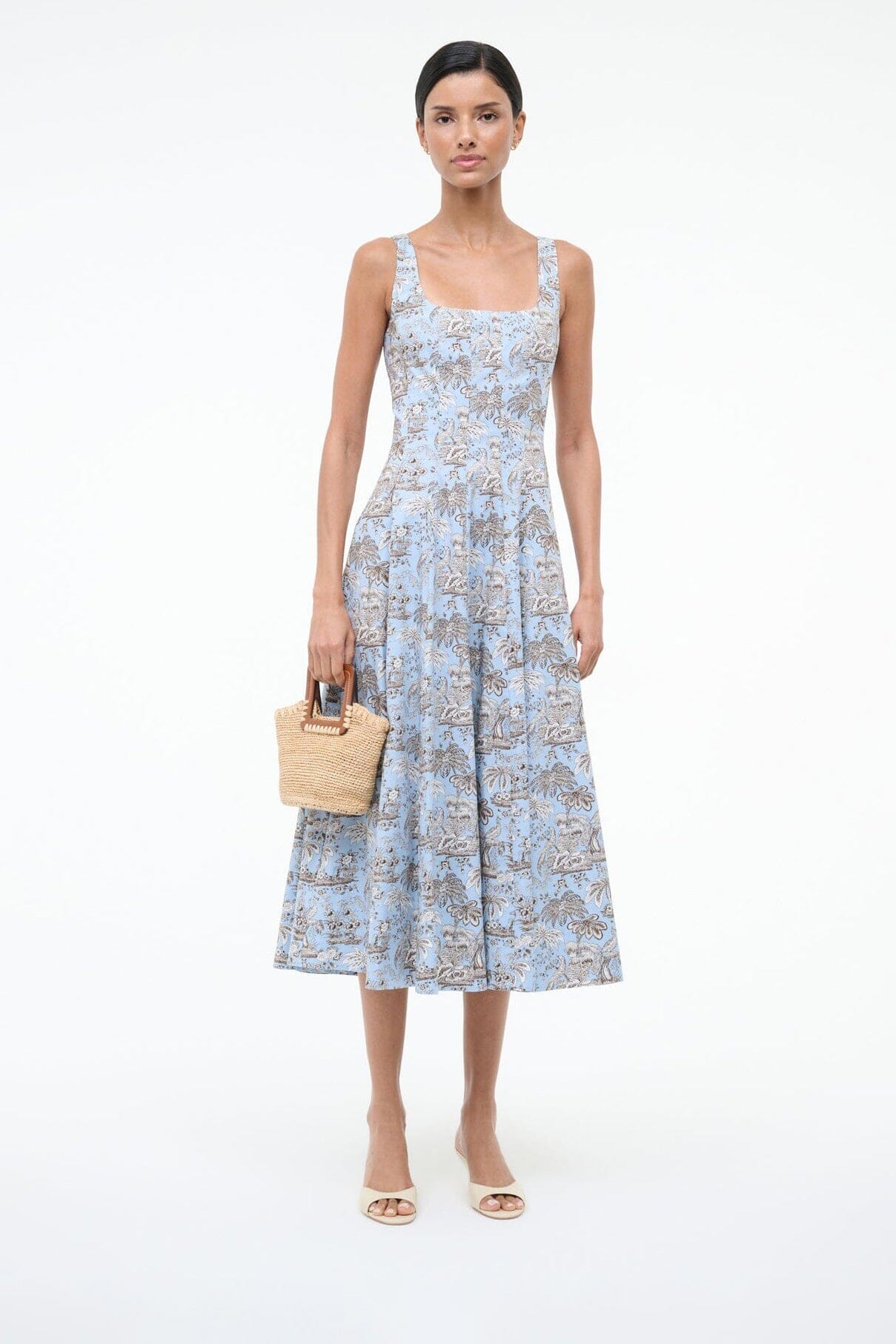 Cream wedge slide sandals worn with a blue floral sundress