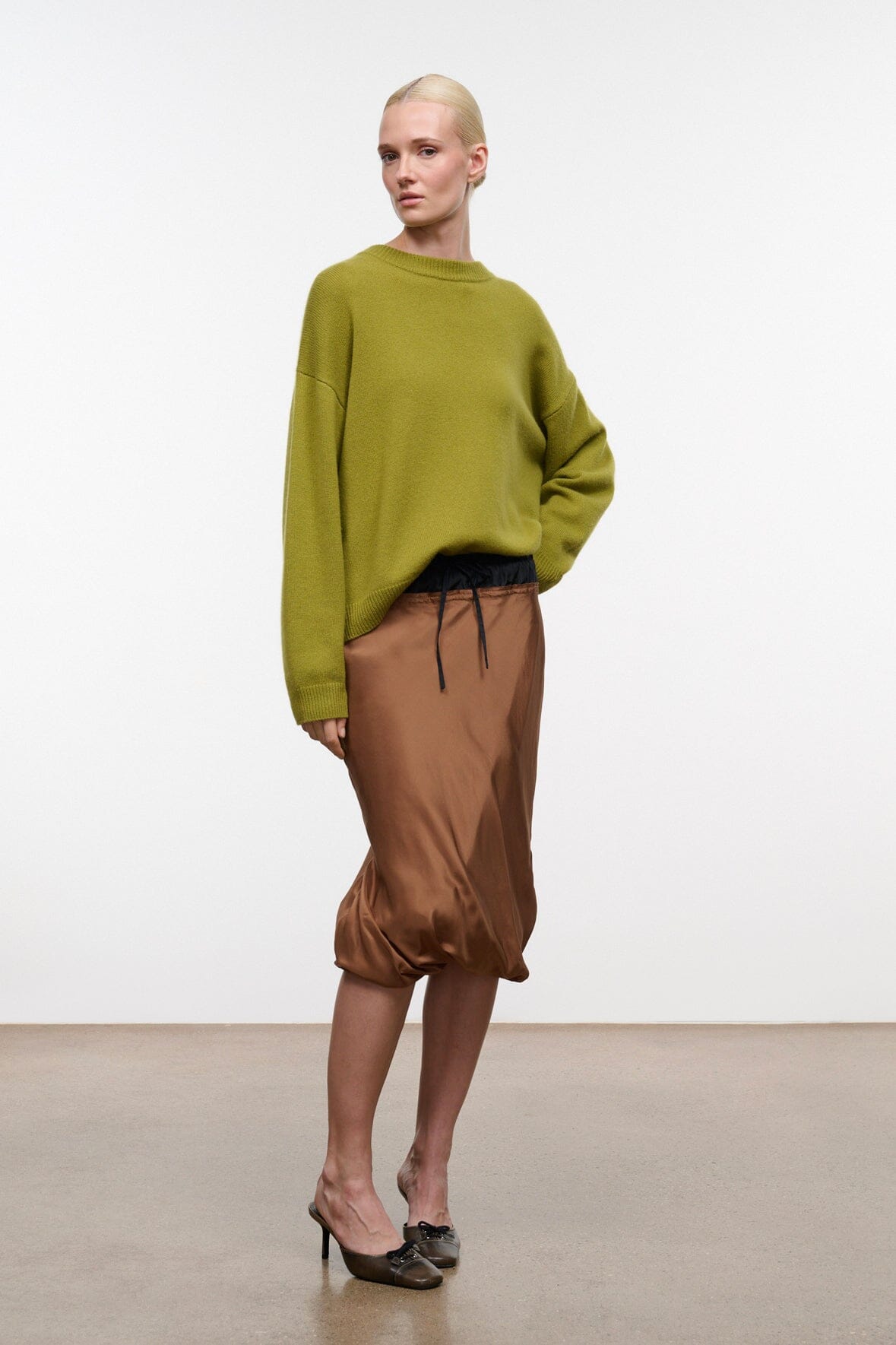 Relaxed cashmere crewneck sweater in green with ribbed neckline, cuffs, and hem.