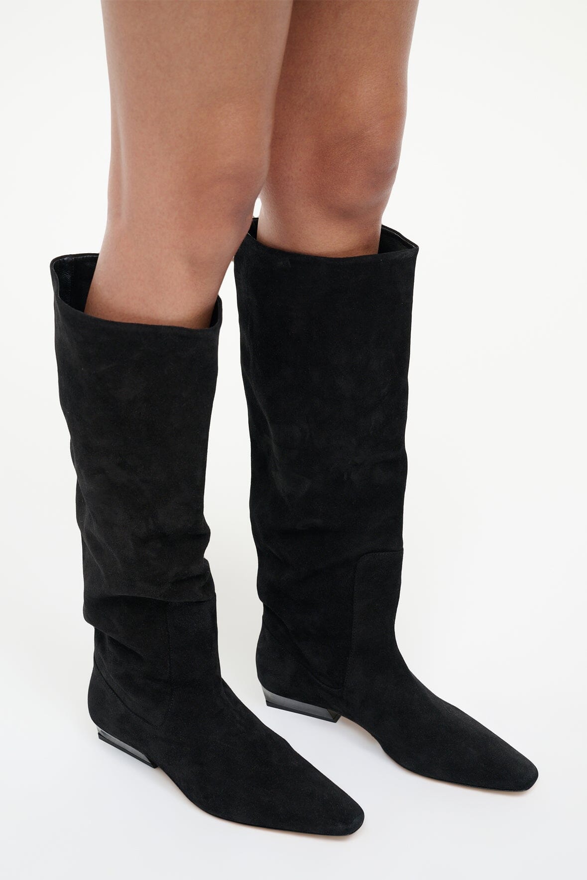 Black suede flat knee boots with low block heel and narrow toe