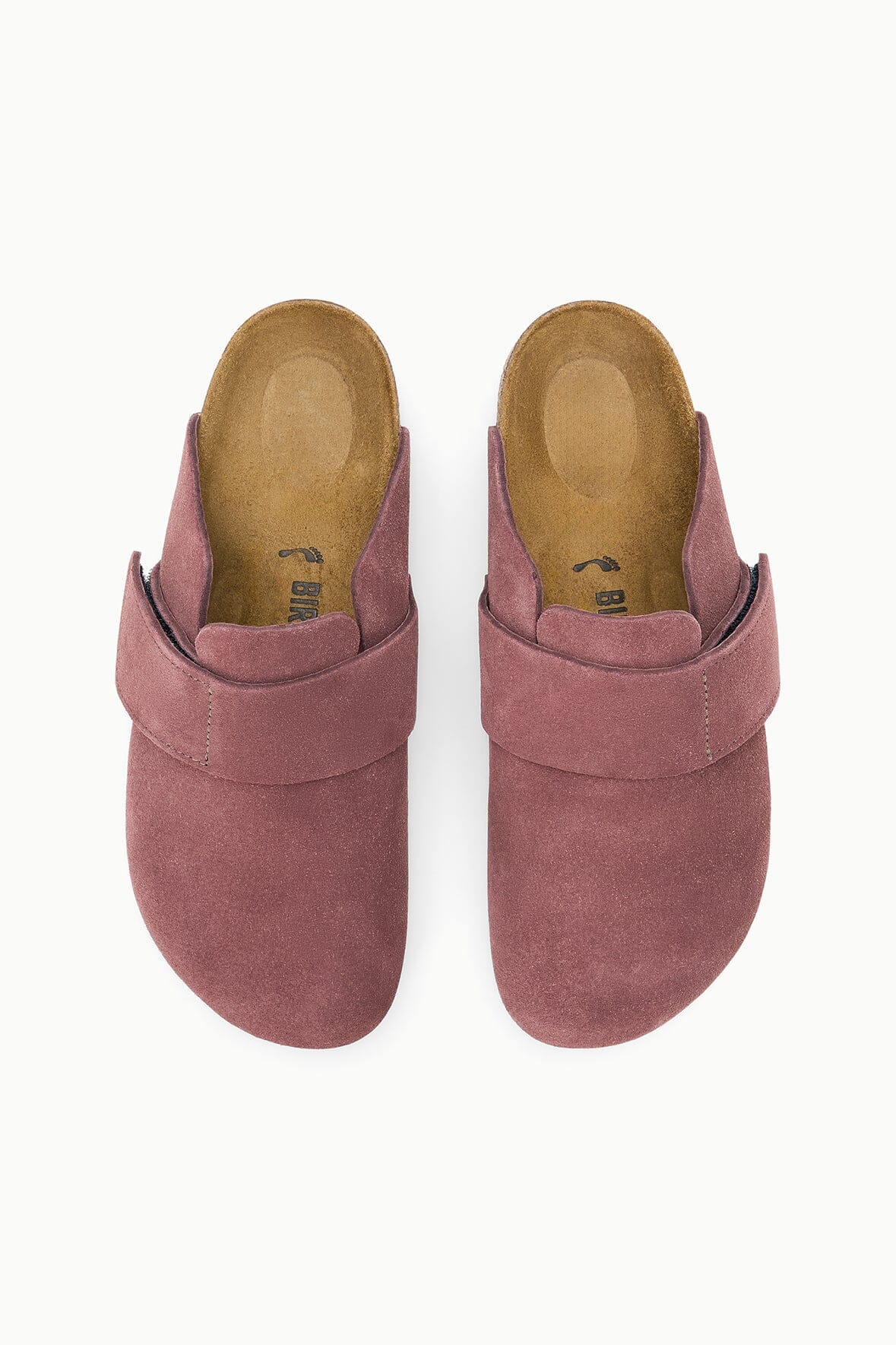 A pair of slip-on clog-style mules in dusty rose pink suede, shown from a top-down view on a clean white background.