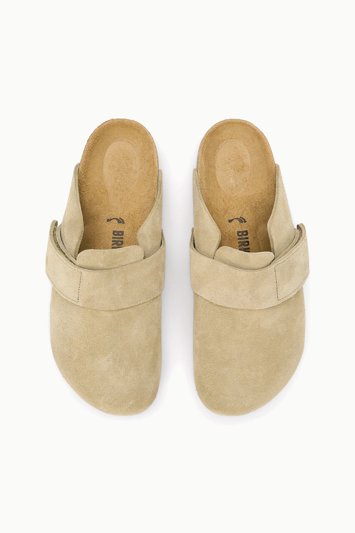 A pair of Birkenstock Bionica slip-on clogs in light tan suede, shown from a top-down view on a white background.