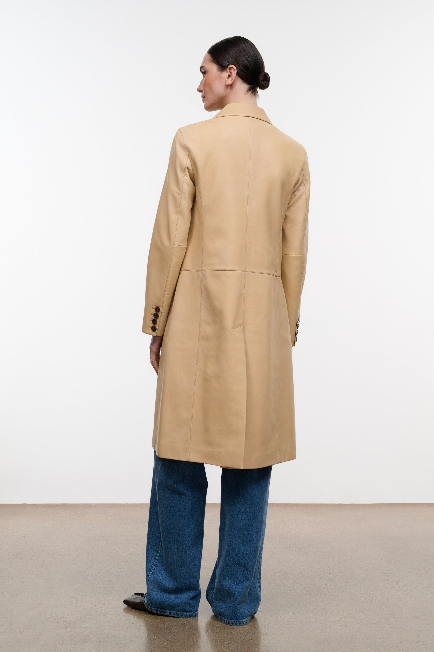 Women's tan leather coat with back yoke and center back seam, long length