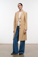 Women's tan leather coat with notch lapels, four front buttons, and flap pockets