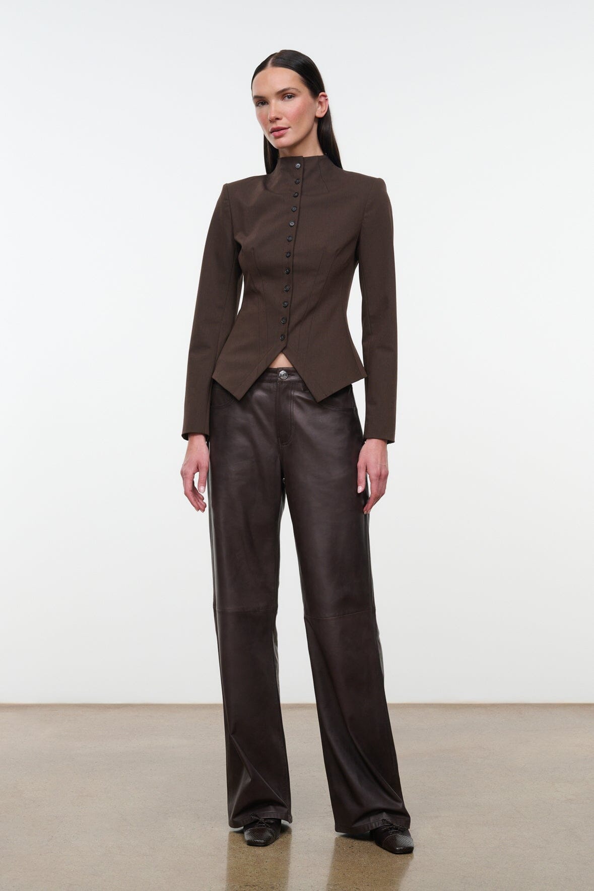 Women's brown fitted jacket with stand collar and button front, tailored waist shape