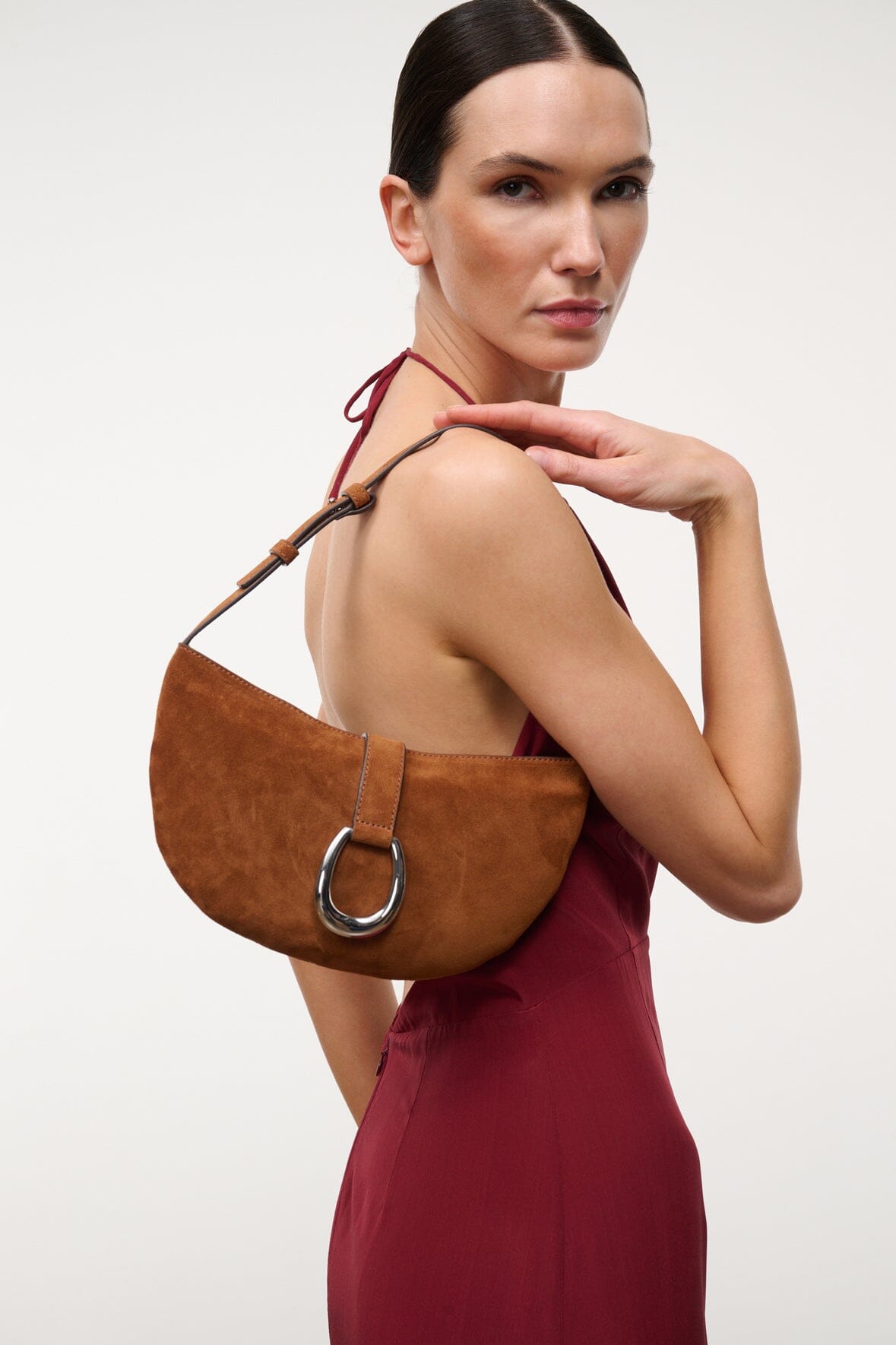 Tabac suede shoulder bag with ring clasp, worn over the shoulder