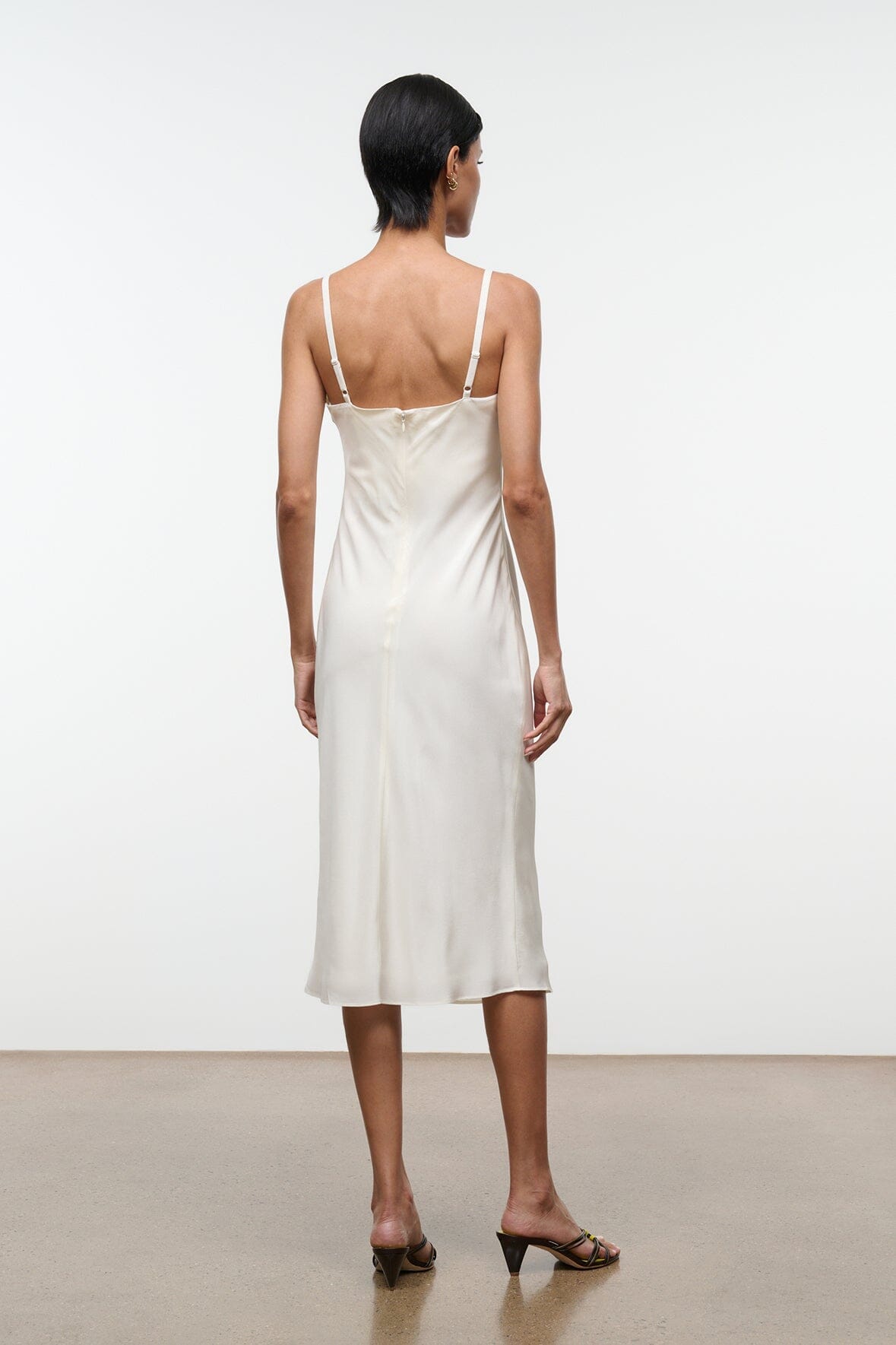 Ivory silk midi slip dress with open back and spaghetti straps
