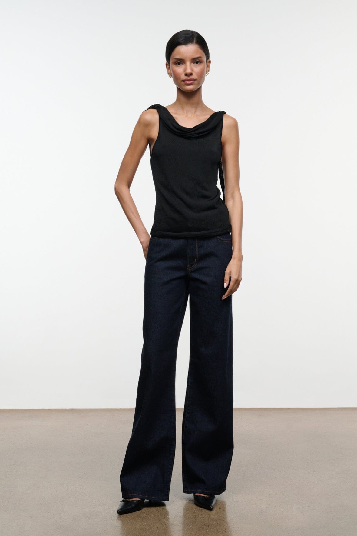 Black sleeveless cowl-neck top with fitted drape and straight hem