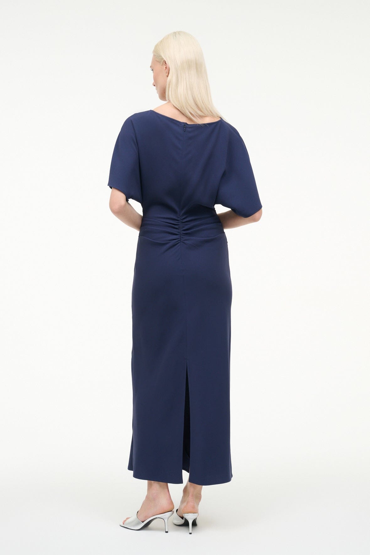 Back of navy midi dress with short batwing sleeves and gathered waist seam