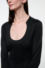 Black long-sleeve scoop-neck top with curved hem and fitted seams