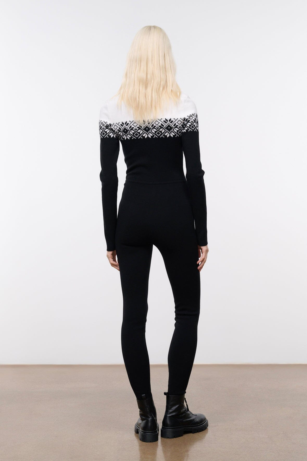 Black snowboard onesie with white fair isle yoke and zip-front, long sleeves, back view