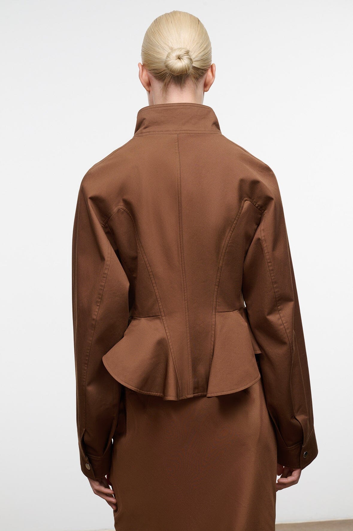 Cigar brown back view of jacket with flared peplum hem and stand collar; patch pockets