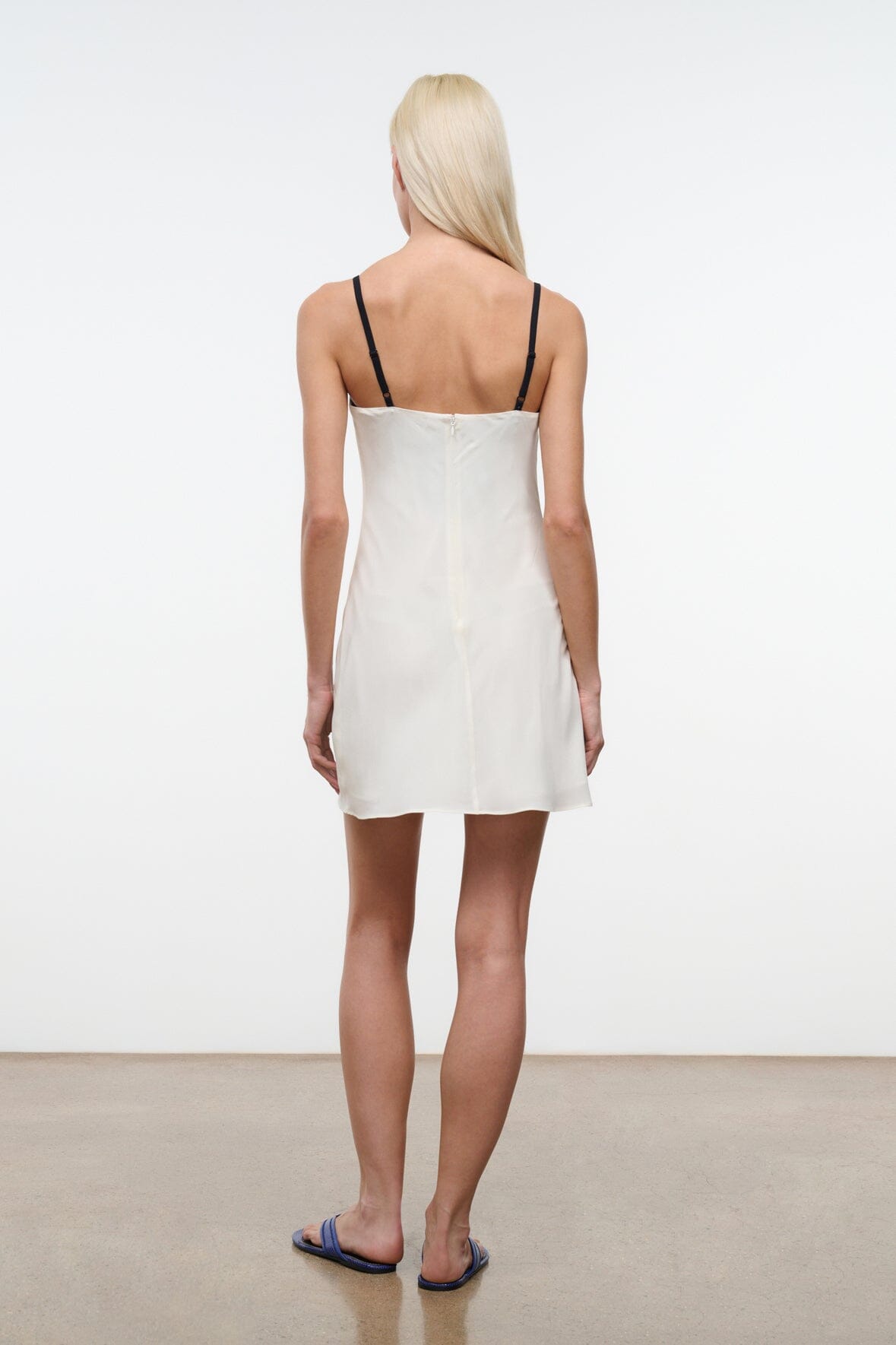 White mini dress back view with spaghetti straps and straight hem