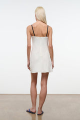 White mini dress back view with spaghetti straps and straight hem