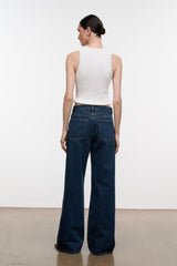 Relaxed dark-wash wide-leg jeans, rear view with patch pockets and belt loops