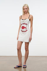 White mini dress with spaghetti straps and black lace trim, red fish graphic front