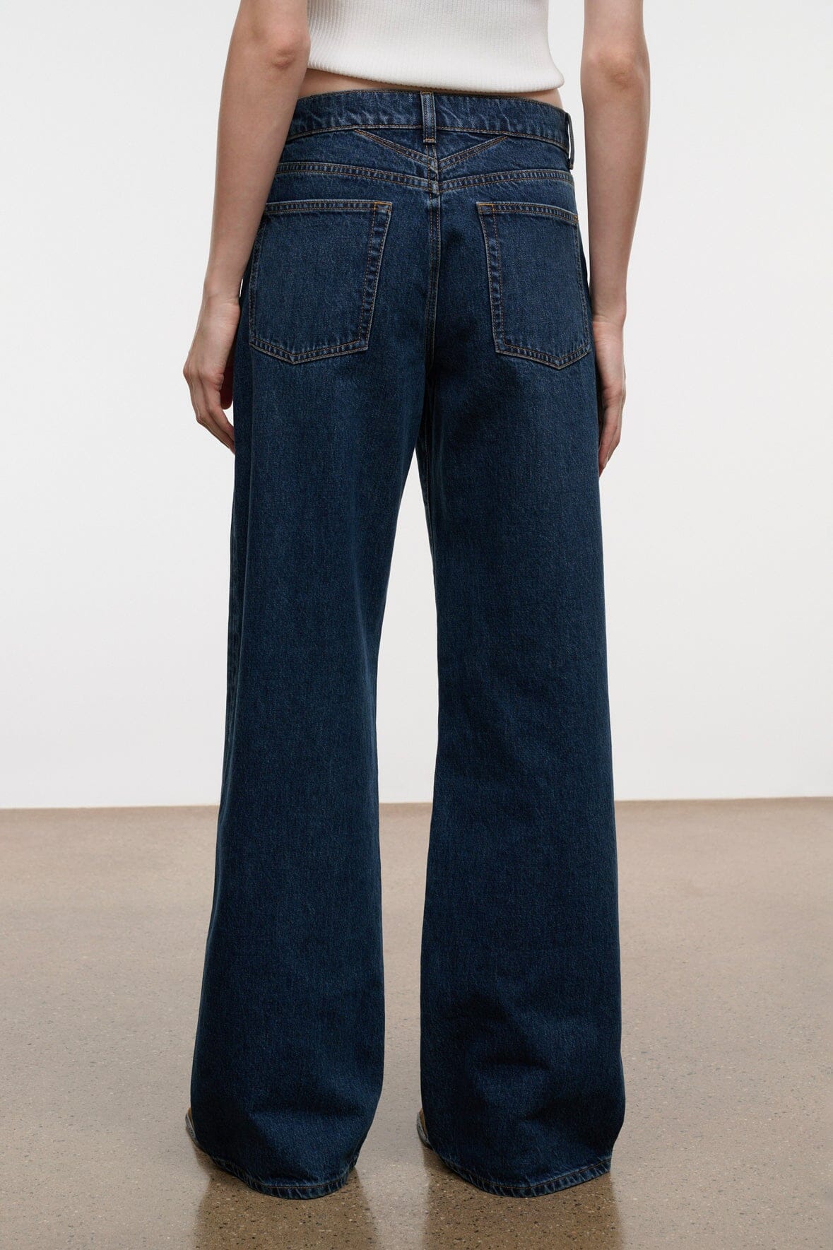 Relaxed dark-wash jeans with wide flared legs and two rear patch pockets