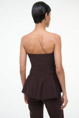 Back view of EVIE strapless peplum top in dark brown with gathered hem