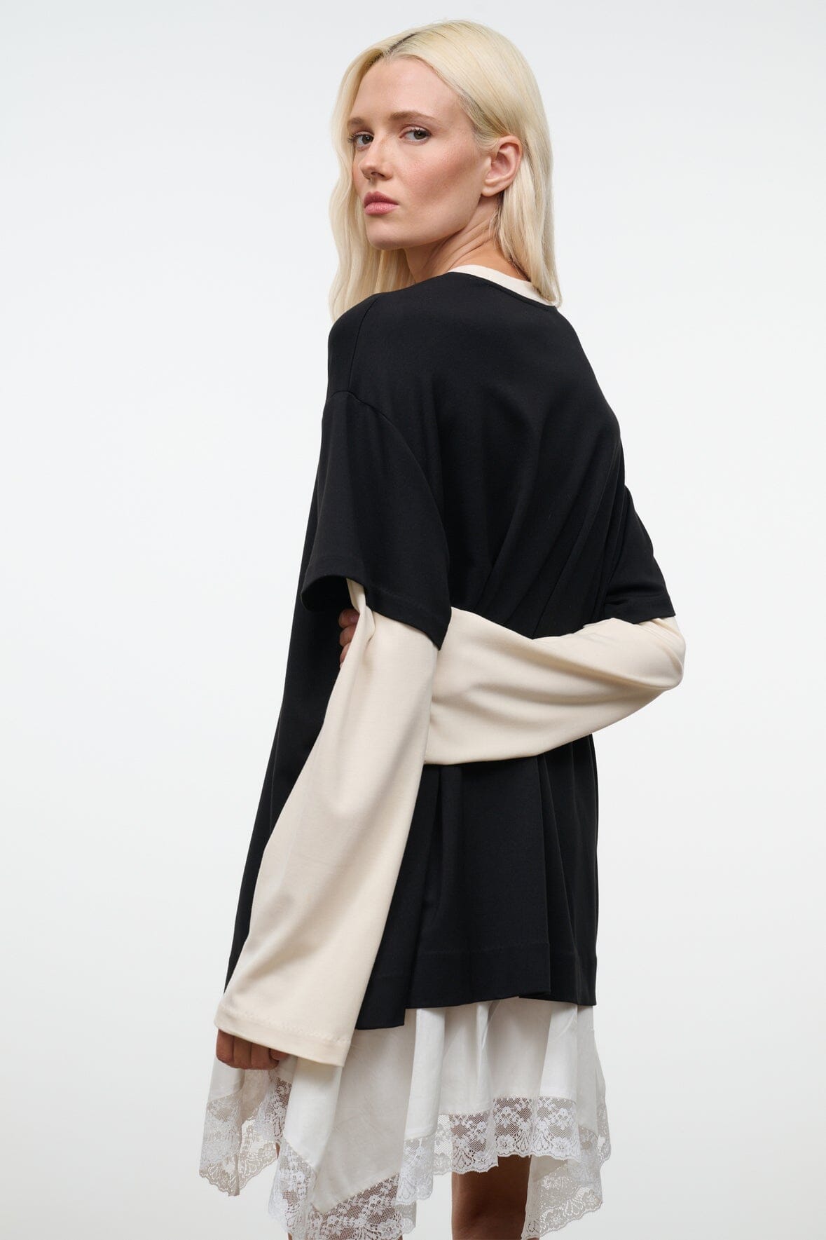 Black tee (back view) with ecru long sleeves extending over the sides