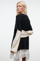 Black tee (back view) with ecru long sleeves extending over the sides