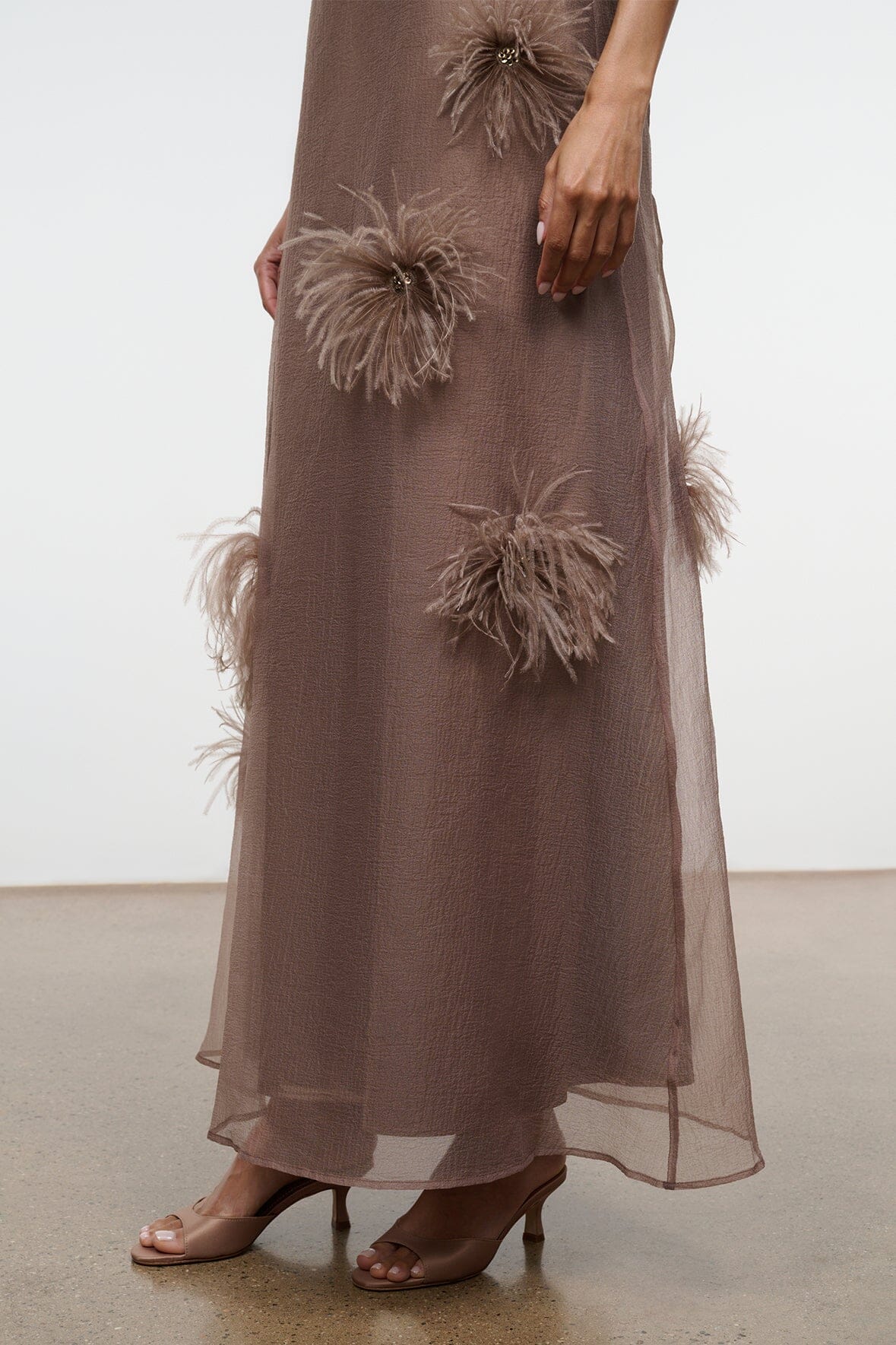 Taupe maxi dress with feather flower appliques along the hem