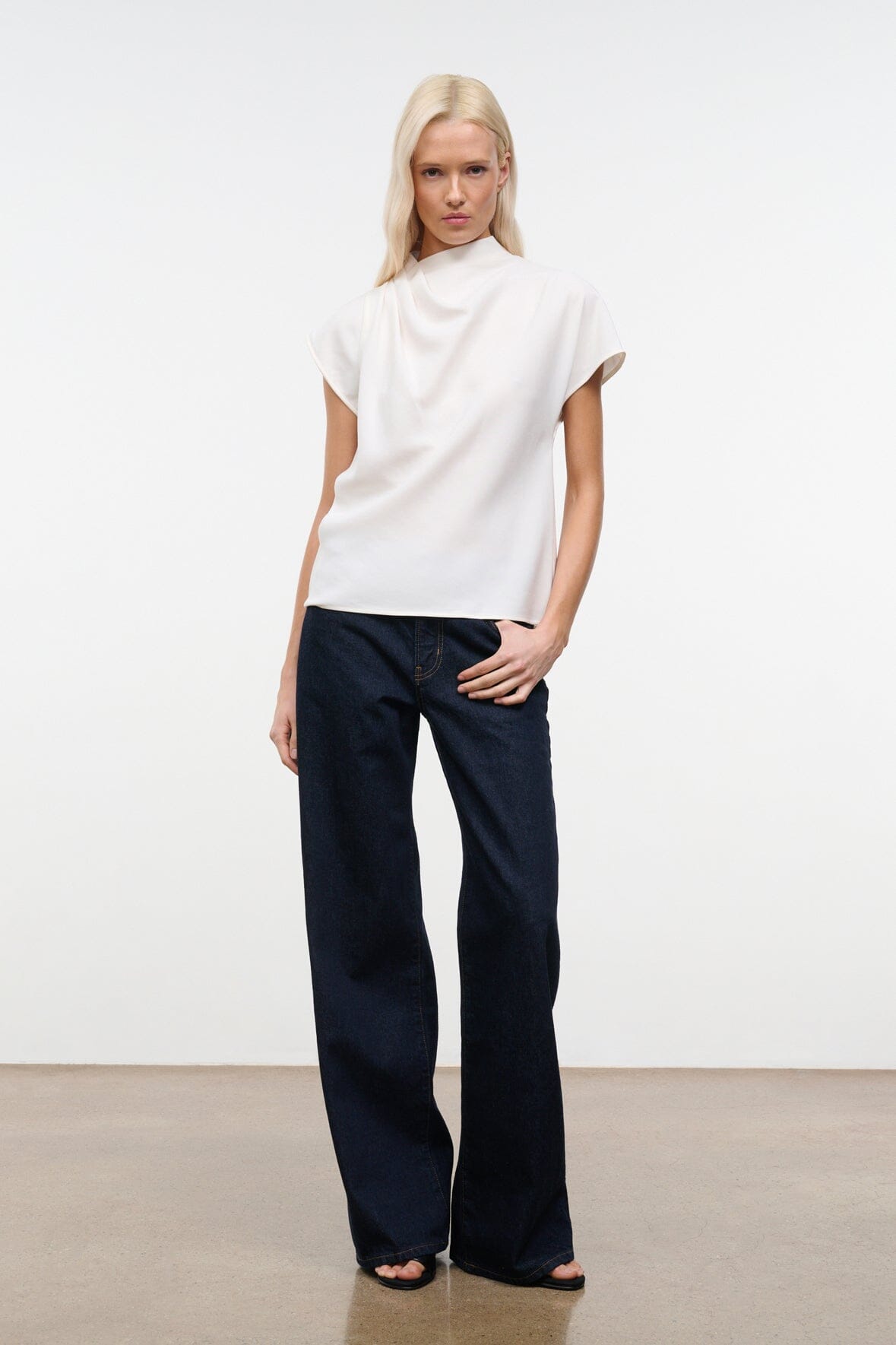 Ivory short-sleeve top with high neck and draped, relaxed fit